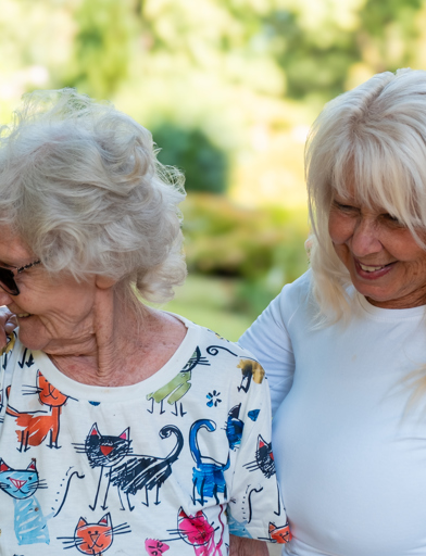 A mother and daughter enjoying the communal gardens at St Crispin 