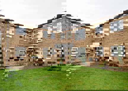 A photo of the side of the building and garden area at Fullylove Court