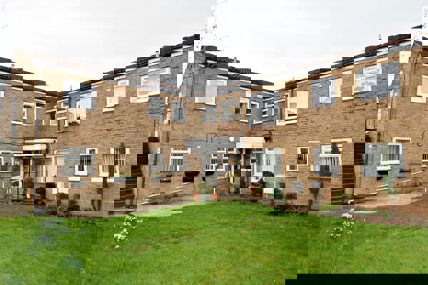 A photo of the side of the building and garden area at Fullylove Court