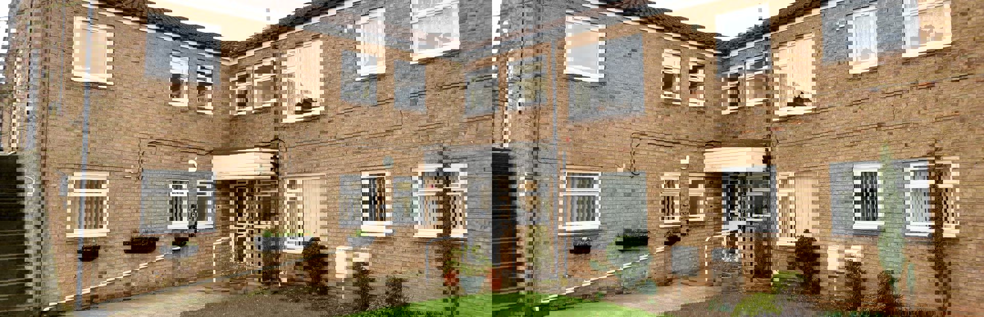 A photo of the side of the building and garden area at Fullylove Court
