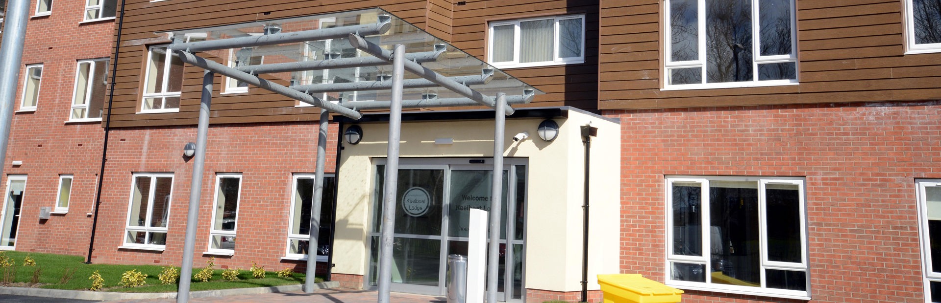 Entrance to with large glass canopy above the doorway Keelboat Lodge