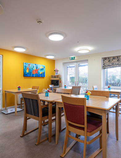 A dining area with tables and chairs 