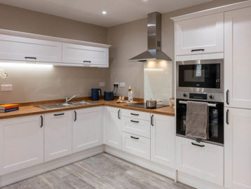 Inside the show home apartment kitchen area with modern units and design
