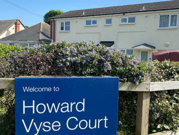 Howard Vyse sign attached to the fencing at the front of the scheme