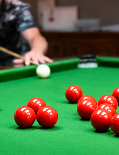 A resident enjoying a game of snooker in the snooker room 