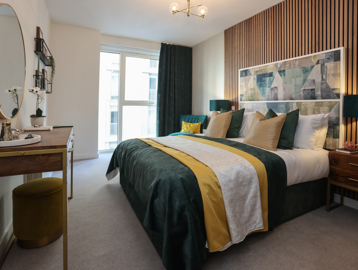 Inside the master bedroom of a show apartment at Minterne Apartments with a double bed and furnishings