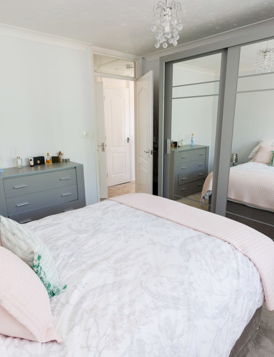 A double bed in the centre of the room with a wardrobe to the foot of the bed and a chest of doors by the entrance 