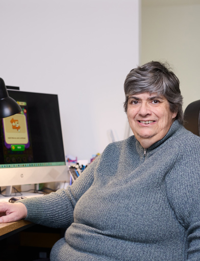 Extra Care resident Debbie sat in front of a computer screen 