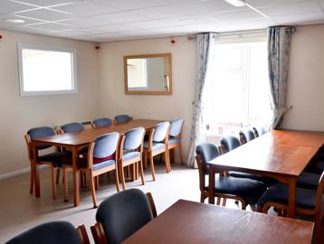 Tables and chairs in the communal dining area of the cafe/ bistro