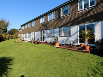 Communal gardens with plants and seating on a large grassed area