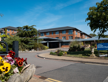 Main entrance to St Crispin Village with large Housing 21 sign
