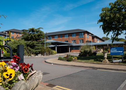 Main entrance to St Crispin Village with large Housing 21 sign