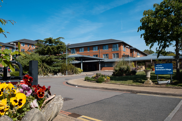 Main entrance to St Crispin Village with large Housing 21 sign