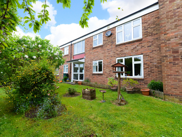 External view of building with garden and bird feeder