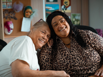 Two female residents smiling and looking to camera