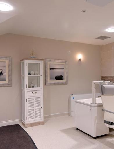 Communal assisted bathroom with bath hoist 