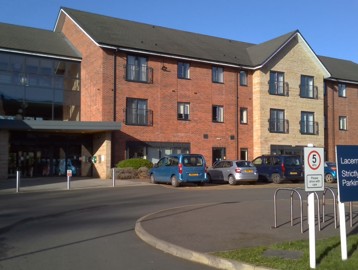 Front entrance of the building to Lacemaker Court with large parking area
