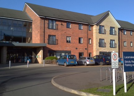 Front entrance of the building to Lacemaker Court with large parking area