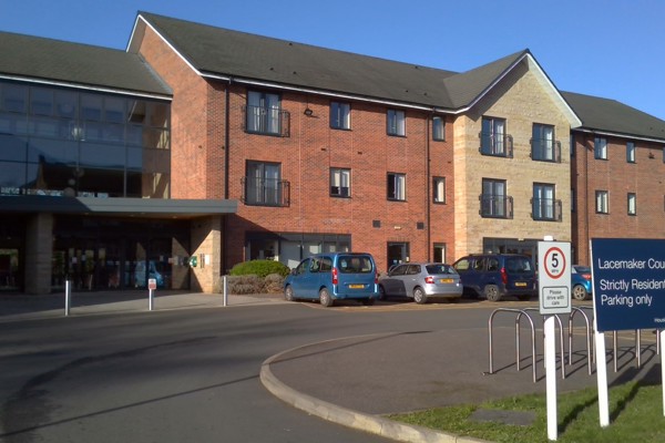 Front entrance of the building to Lacemaker Court with large parking area