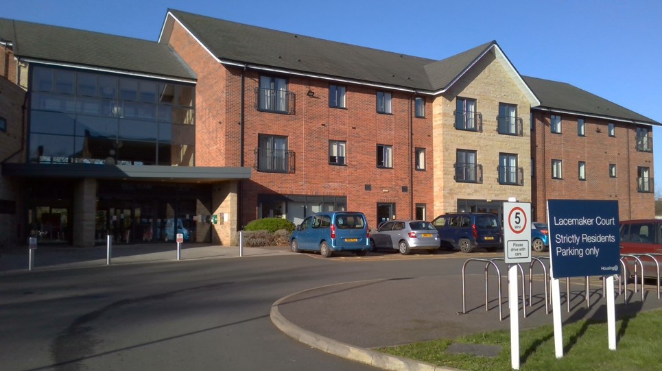 Front entrance of the building to Lacemaker Court with large parking area