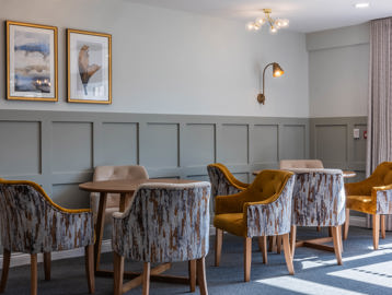 Large communal area with seating and tables to relax in