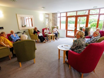 Residents relaxing together in the communal lounge at Mere View