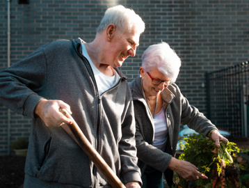 A couple in the allotment of the communal gardens at Lime Gardens