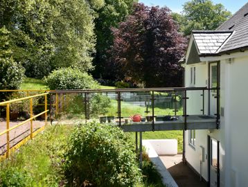 Garden and walkway to the back of the apartments on a sunny day